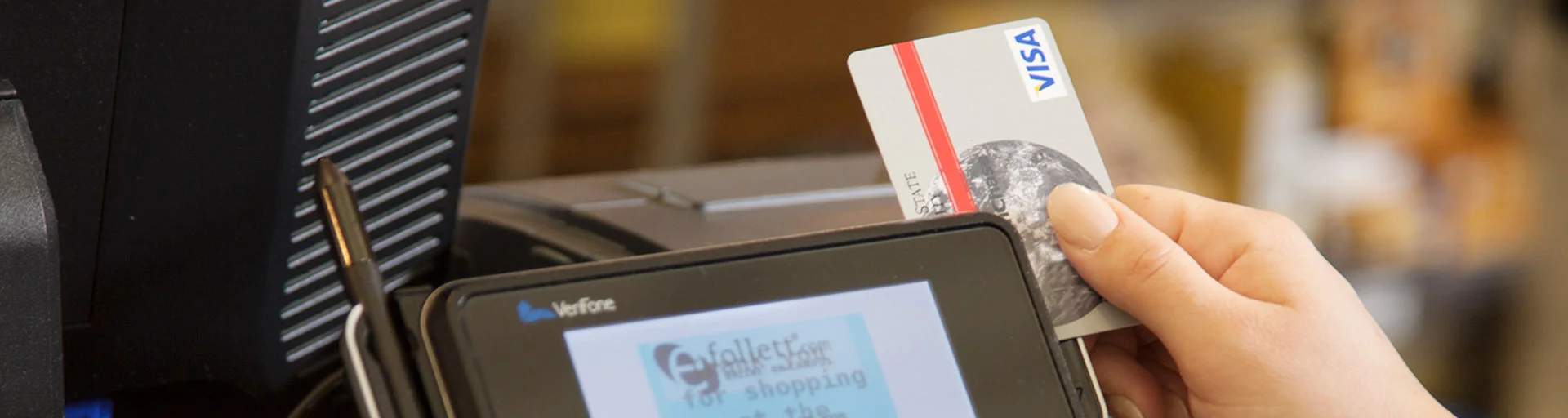 A Purchasing card being used on a store card reader
