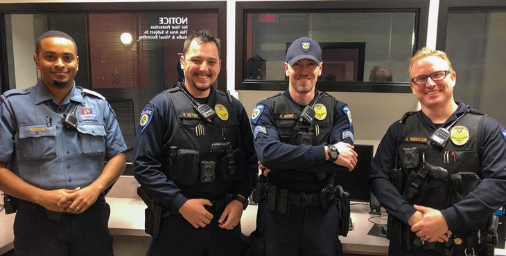 Photograph of four smiling police officers from the west campus