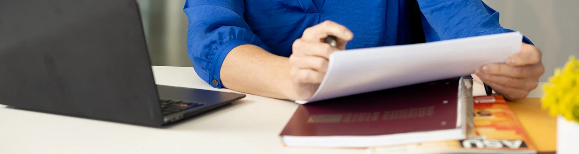 An ASU employee looking over some paper forms